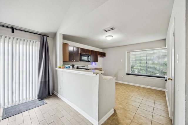 16211 Beck Ridge Dr, Houston, TX 77053 - kitchen with black microwave, stainless steel electric range oven, a peninsula, baseboards, and dark brown cabinetry