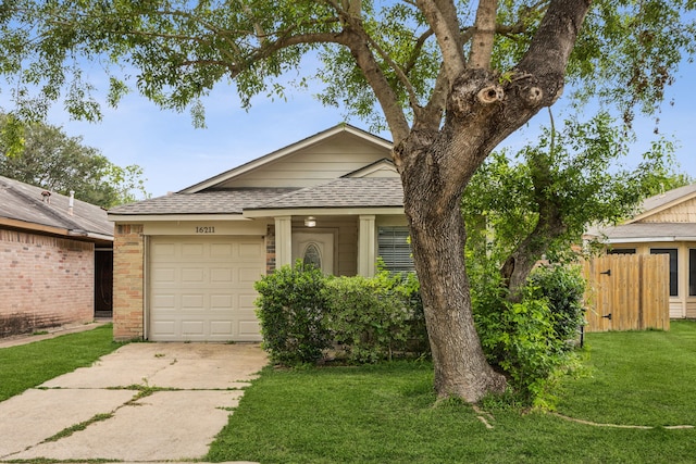 16211 Beck Ridge Dr, Houston, TX 77053 - view of front facade with driveway, roof with shingles, an attached garage, a front lawn, and brick siding