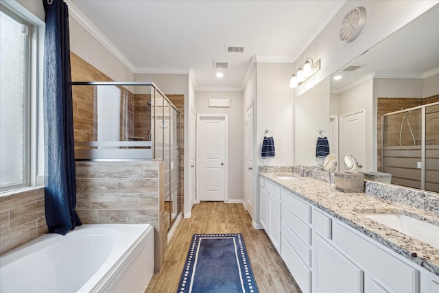 4423 Mimic Dr, Spring, TX 77386 - bathroom featuring a stall shower, double vanity, a garden tub, healthy amount of natural light, and ornamental molding