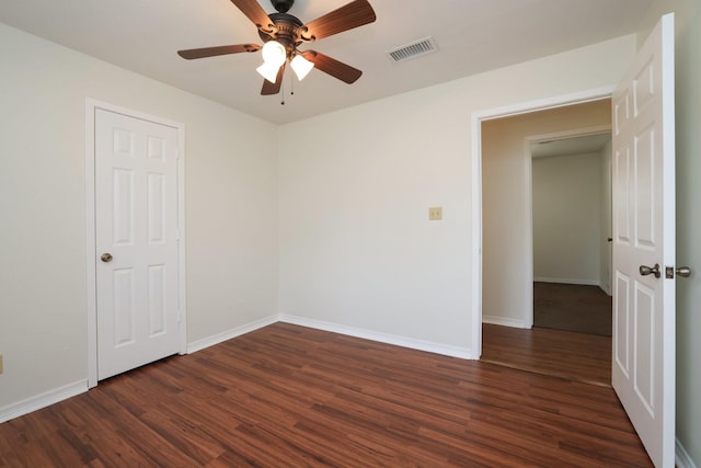 3000 Stevens Dr, Bryan, TX 77803 - empty room featuring dark wood-style flooring, a ceiling fan, and baseboards