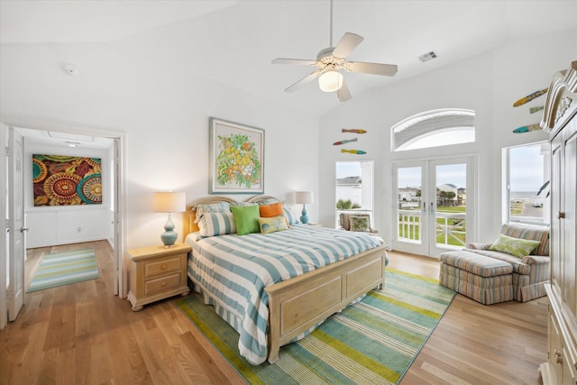 4100 Sand Crab Ln, Galveston, TX 77554 - bedroom featuring access to outside, french doors, light wood-type flooring, ceiling fan, and a towering ceiling