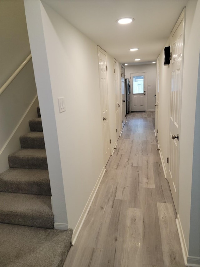12907 Trail Hollow Dr Unit 2907, Houston, TX 77079 - hall with light wood finished floors, stairs, baseboards, and recessed lighting
