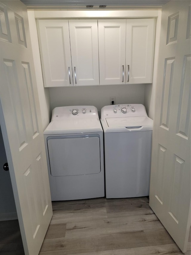12907 Trail Hollow Dr Unit 2907, Houston, TX 77079 - laundry area with independent washer and dryer, cabinet space, and light wood finished floors