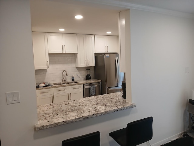 12907 Trail Hollow Dr Unit 2907, Houston, TX 77079 - kitchen featuring a sink, appliances with stainless steel finishes, tasteful backsplash, white cabinetry, and recessed lighting