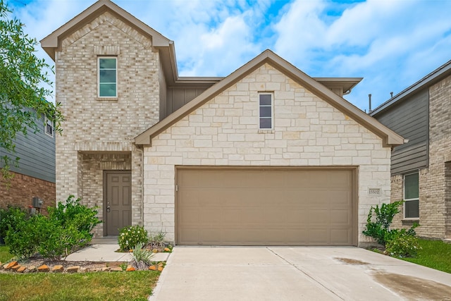 15502 Islandview Ln, Houston, TX 77053 - view of front of property featuring driveway, an attached garage, stone siding, and board and batten siding
