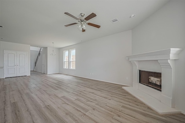 15502 Islandview Ln, Houston, TX 77053 - unfurnished living room with a ceiling fan, light wood-style floors, baseboards, and a fireplace with raised hearth