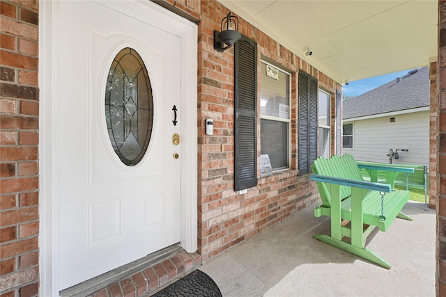 14251 Winecup Ln, Houston, TX 77047 - doorway to property featuring brick siding and covered porch