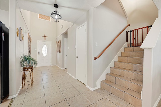 14251 Winecup Ln, Houston, TX 77047 - foyer entrance with light tile patterned floors, stairs, and baseboards