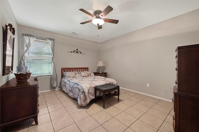 14251 Winecup Ln, Houston, TX 77047 - bedroom featuring light tile patterned flooring, baseboards, and a ceiling fan