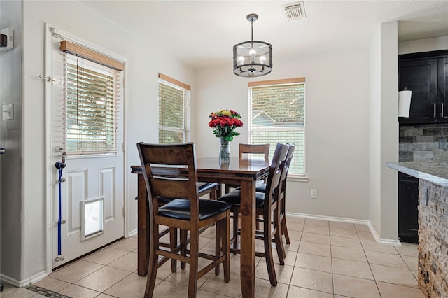 14251 Winecup Ln, Houston, TX 77047 - dining room featuring plenty of natural light, a chandelier, and light tile patterned flooring