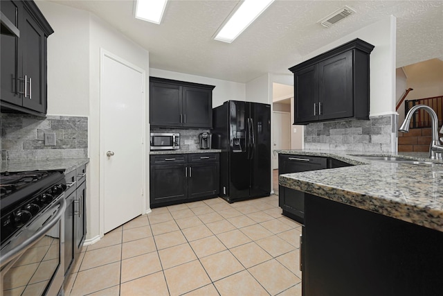 14251 Winecup Ln, Houston, TX 77047 - kitchen with stainless steel appliances, a sink, decorative backsplash, and light stone counters
