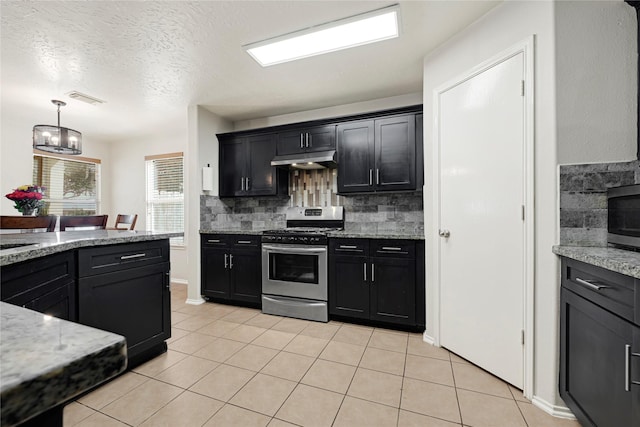 14251 Winecup Ln, Houston, TX 77047 - kitchen with stainless steel appliances, under cabinet range hood, tasteful backsplash, light tile patterned floors, and light stone counters