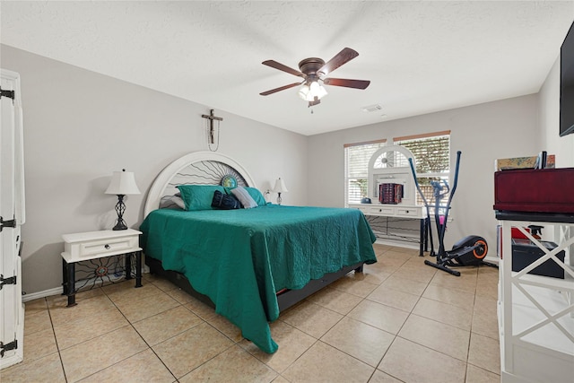 14251 Winecup Ln, Houston, TX 77047 - bedroom with light tile patterned floors, a ceiling fan, a textured ceiling, and baseboards
