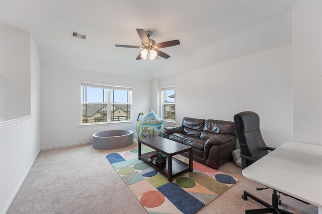 12526 Sabine Point Dr, Humble, TX 77346 - carpeted living room with a ceiling fan, a desk, and baseboards