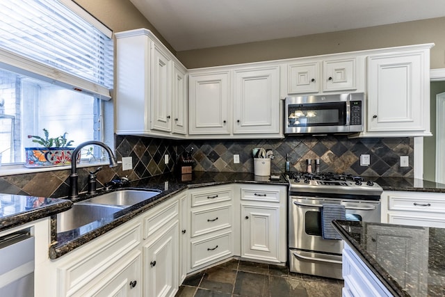 717 Overbrook, Huntsville, TX 77340 - kitchen with stainless steel appliances, a sink, white cabinets, tasteful backsplash, and dark stone countertops