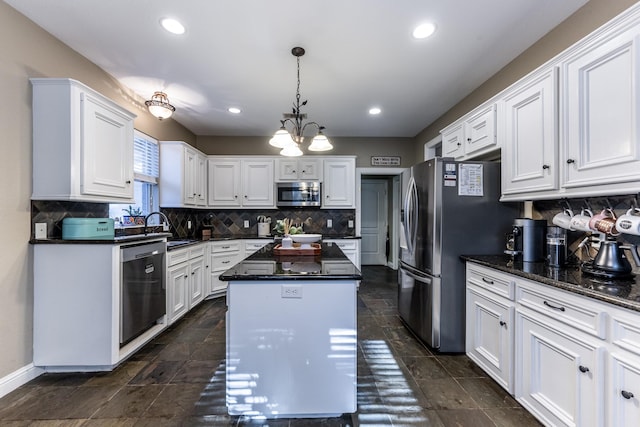 717 Overbrook, Huntsville, TX 77340 - kitchen featuring stainless steel appliances, a center island, white cabinets, decorative backsplash, and recessed lighting
