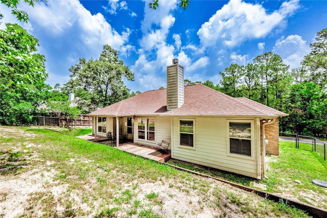 717 Overbrook, Huntsville, TX 77340 - back of property with a chimney and a deck