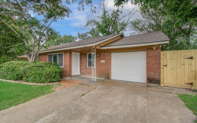 4621 W 43rd St, Houston, TX 77092 - ranch-style house with brick siding, an attached garage, driveway, roof with shingles, and a gate