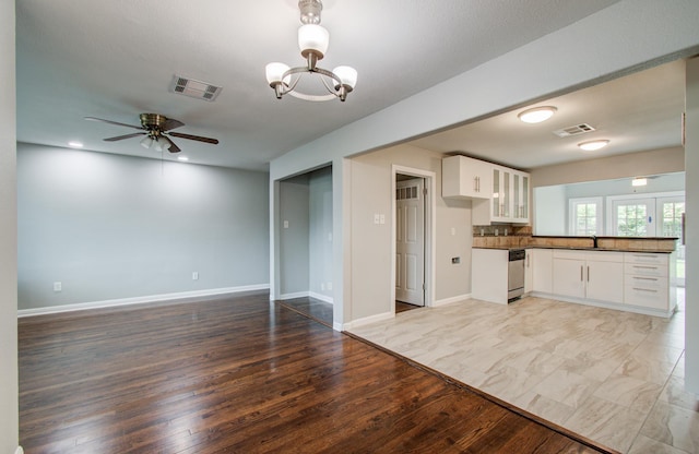 4621 W 43rd St, Houston, TX 77092 - kitchen with dark countertops, open floor plan, glass insert cabinets, ceiling fan, and light wood-style floors