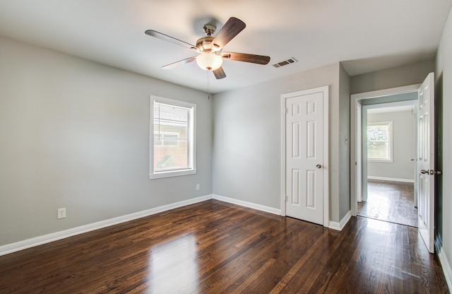 4621 W 43rd St, Houston, TX 77092 - unfurnished bedroom featuring dark wood finished floors, baseboards, a closet, and ceiling fan