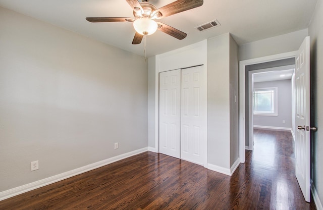 4621 W 43rd St, Houston, TX 77092 - unfurnished bedroom with dark wood finished floors, baseboards, a closet, and a ceiling fan