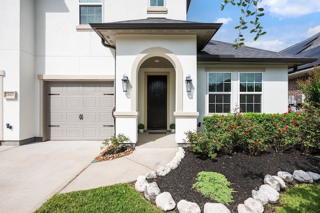 25007 Coperti Ln, Spring, TX 77386 - view of exterior entry featuring stucco siding, driveway, and a shingled roof