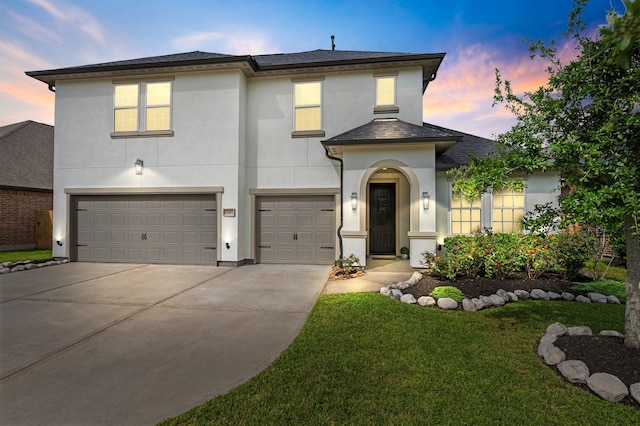 25007 Coperti Ln, Spring, TX 77386 - view of front of house featuring stucco siding, an attached garage, concrete driveway, and a lawn