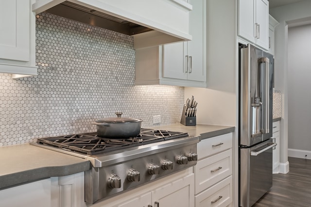 25007 Coperti Ln, Spring, TX 77386 - kitchen featuring stainless steel appliances, custom range hood, backsplash, white cabinets, and dark wood-style flooring
