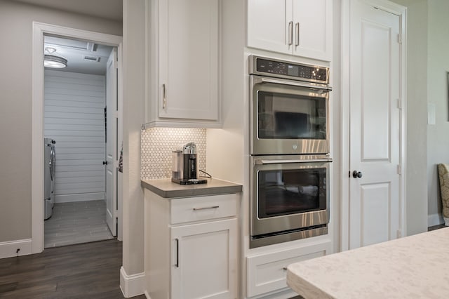 25007 Coperti Ln, Spring, TX 77386 - kitchen with stainless steel double oven, baseboards, dark wood-style flooring, and light countertops