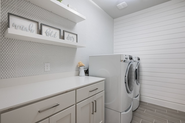 25007 Coperti Ln, Spring, TX 77386 - laundry area featuring washer and dryer, wood finish floors, and cabinet space