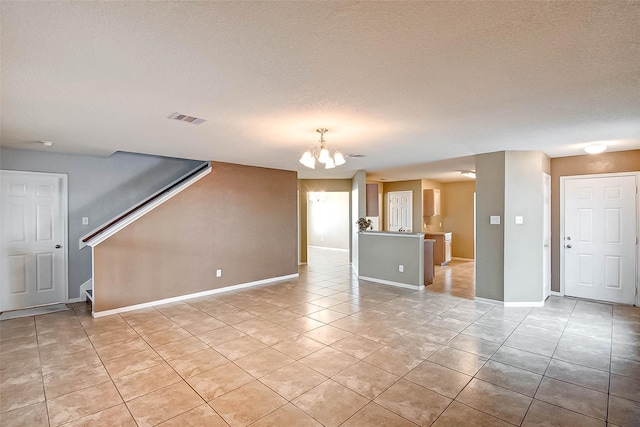 1230 Piedmont Creek Trl, Houston, TX 77073 - unfurnished living room featuring a chandelier, light tile patterned floors, stairs, baseboards, and a textured ceiling