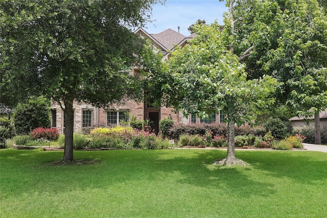 5451 Harvest Oak Landing Dr, Spring, TX 77386 - obstructed view of property with a front lawn and brick siding