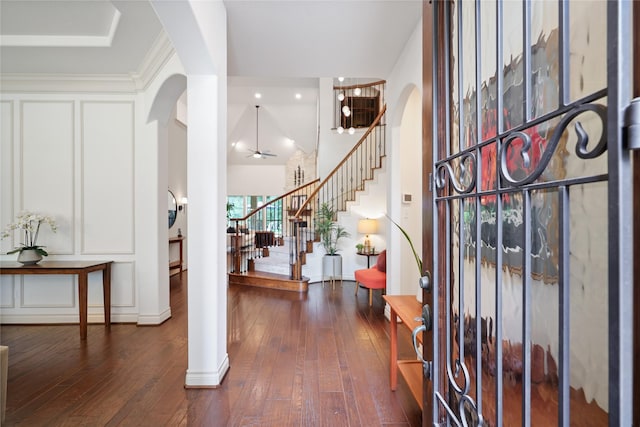 5451 Harvest Oak Landing Dr, Spring, TX 77386 - foyer featuring arched walkways, dark wood-style floors, stairway, and a high ceiling