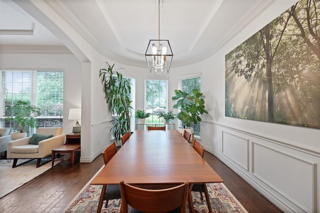 5451 Harvest Oak Landing Dr, Spring, TX 77386 - dining area featuring a raised ceiling, dark wood-style floors, a chandelier, healthy amount of natural light, and ornamental molding