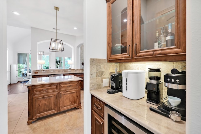 5451 Harvest Oak Landing Dr, Spring, TX 77386 - bar area featuring tasteful backsplash, hanging light fixtures, recessed lighting, arched walkways, and stainless steel dishwasher