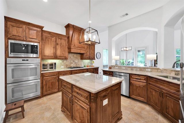 5451 Harvest Oak Landing Dr, Spring, TX 77386 - kitchen featuring appliances with stainless steel finishes, arched walkways, a sink, healthy amount of natural light, and recessed lighting