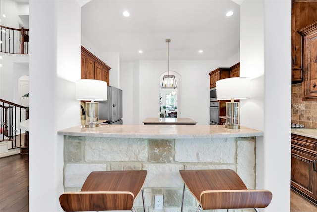 5451 Harvest Oak Landing Dr, Spring, TX 77386 - kitchen featuring tasteful backsplash, wall oven, recessed lighting, a peninsula, and stainless steel microwave