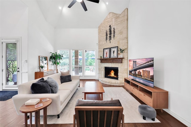 5451 Harvest Oak Landing Dr, Spring, TX 77386 - living room with high vaulted ceiling, a ceiling fan, a fireplace, wood finished floors, and baseboards