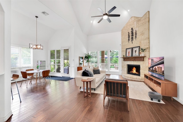 5451 Harvest Oak Landing Dr, Spring, TX 77386 - living area with high vaulted ceiling, a fireplace, dark wood-style floors, ceiling fan, and a chandelier