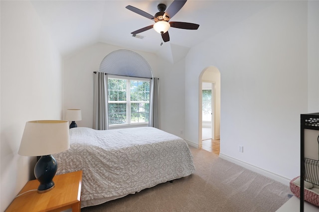 5451 Harvest Oak Landing Dr, Spring, TX 77386 - bedroom featuring arched walkways, lofted ceiling, carpet flooring, a ceiling fan, and baseboards