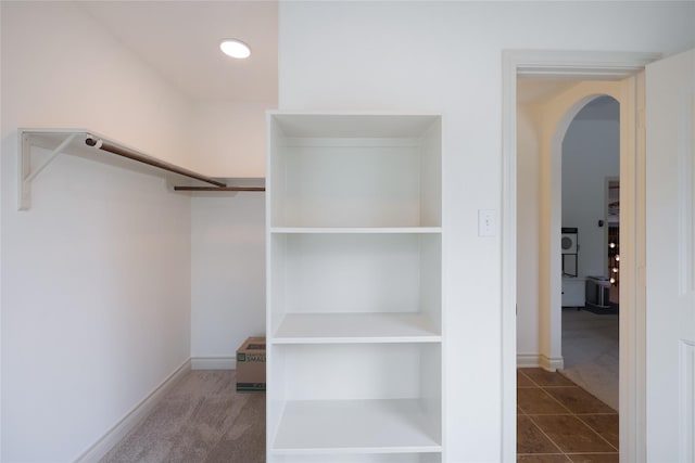 5451 Harvest Oak Landing Dr, Spring, TX 77386 - walk in closet featuring arched walkways and carpet flooring