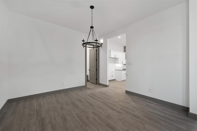 1806 Athens Dr, Roman Forest, TX 77357 - unfurnished dining area featuring a chandelier, dark wood-style floors, baseboards, and recessed lighting
