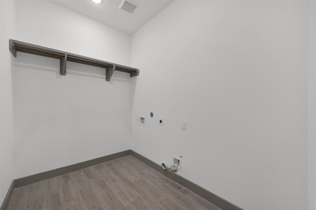 1806 Athens Dr, Roman Forest, TX 77357 - laundry room featuring hookup for a gas dryer, hookup for an electric dryer, washer hookup, baseboards, and wood finished floors