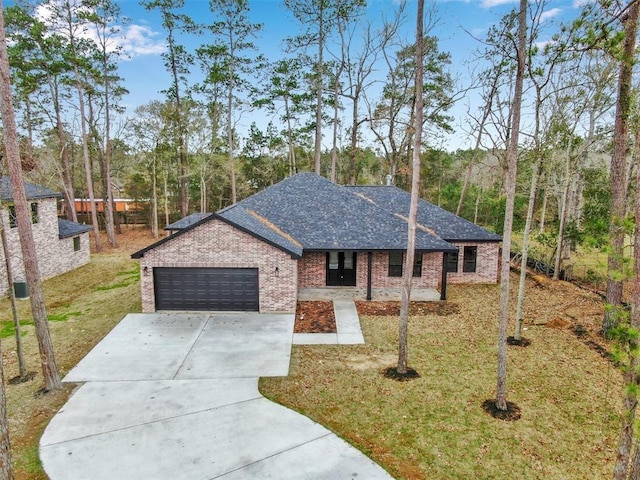 1806 Athens Dr, Roman Forest, TX 77357 - view of front of property with driveway, an attached garage, brick siding, a front lawn, and roof with shingles