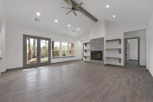 1806 Athens Dr, Roman Forest, TX 77357 - unfurnished living room with beam ceiling, ceiling fan, high vaulted ceiling, french doors, and wood finished floors