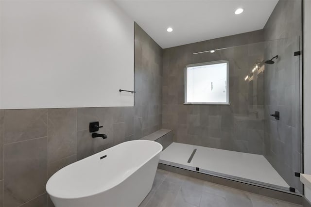 1806 Athens Dr, Roman Forest, TX 77357 - bathroom with tile walls, a freestanding bath, tiled shower, tile patterned flooring, and recessed lighting