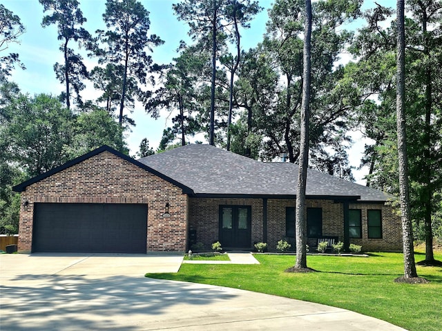 1806 Athens Dr, Roman Forest, TX 77357 - view of front facade with brick siding, concrete driveway, french doors, and a garage