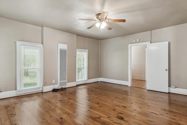 1498 Fm 279, Ben Wheeler, TX 75754 - empty room with a heating unit, a ceiling fan, wood-type flooring, and baseboards