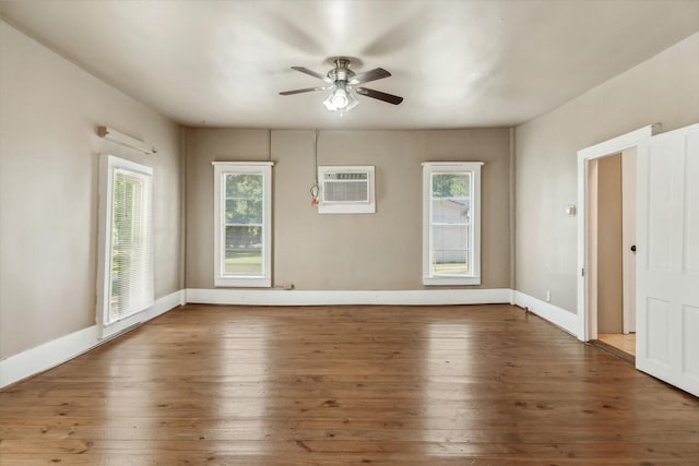 1498 Fm 279, Ben Wheeler, TX 75754 - unfurnished room with a wall unit AC, a ceiling fan, wood-type flooring, and baseboards