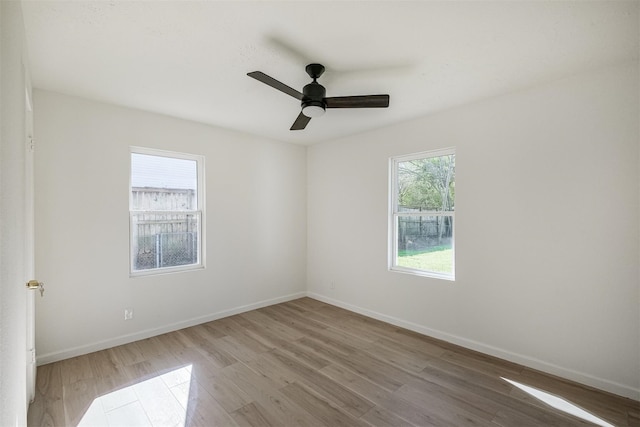 9419 Campbell Rd, Houston, TX 77080 - empty room with wood finished floors, a ceiling fan, and baseboards